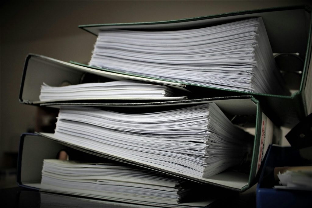 pexels-photo-357514-357514 Close-up of stacked binders filled with documents for office or educational use.
